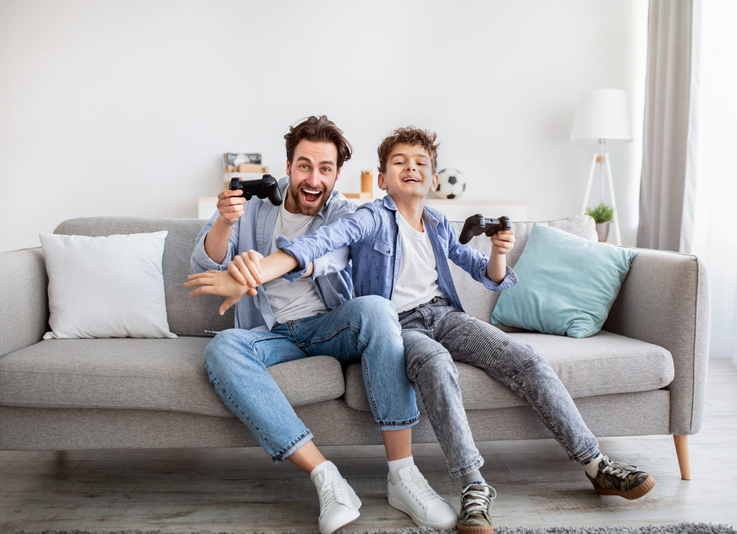 The Health Benefits of Video games blog, dad and son playing video games together